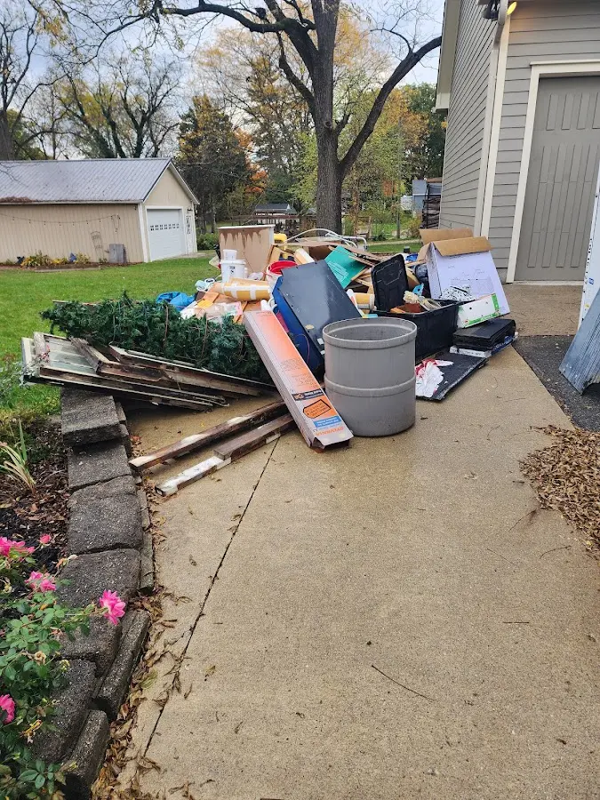Dumpster being loaded with debris for Demolition Dumpster Rental in Huber Ridge